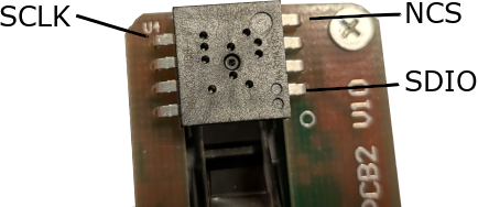 physical PMW3320DB-TYDU IC with SDIO, NCS, and SCLK labeled